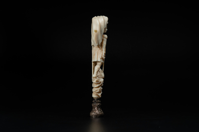 An ivory and silver seal stamp with a hussar handle, 19th C.
