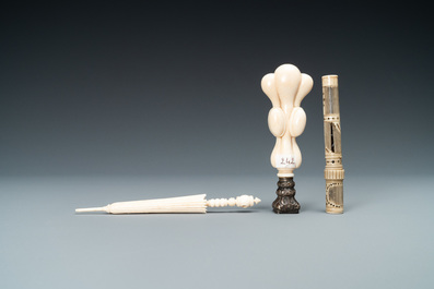 An ivory 'Stanhope' miniature umbrella with microscopical views on Paris, a seal stamp and a bone needle case, 19th C.