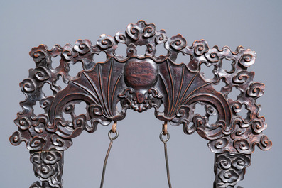 A Chinese bronze gong set in a carved wooden stand, 19th C.