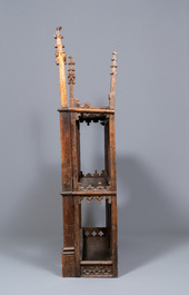 A carved oak shelf with pinnacles and stylised flowers and carved panels, 15th C. and later