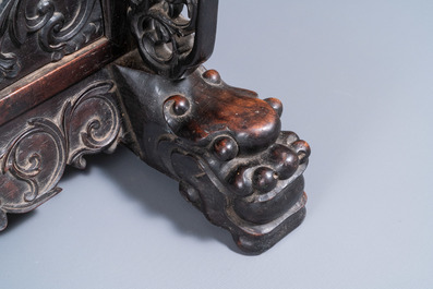 A Chinese bronze gong set in a carved wooden stand, 19th C.