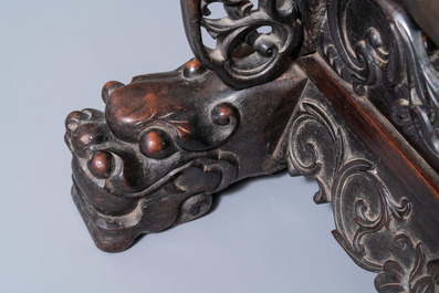 A Chinese bronze gong set in a carved wooden stand, 19th C.