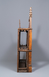 A carved oak shelf with pinnacles and stylised flowers and carved panels, 15th C. and later
