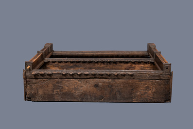 A carved oak shelf with pinnacles and stylised flowers and carved panels, 15th C. and later