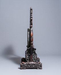 A Chinese bronze gong set in a carved wooden stand, 19th C.