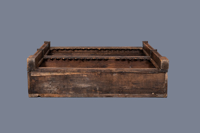 A carved oak shelf with pinnacles and stylised flowers and carved panels, 15th C. and later