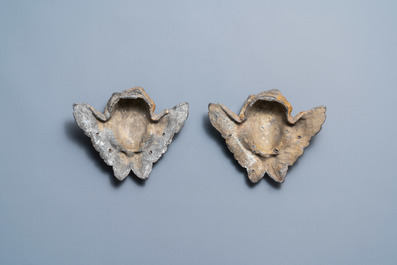 A pair of parcel-gilt lead winged cherub heads, 17th C.