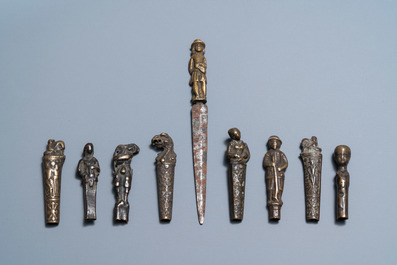 Nine bronze and brass knife handles including one with a knife, 16/18th C.