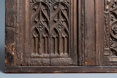 A carved oak front panel of a coffer with tracery panels, 15th C.