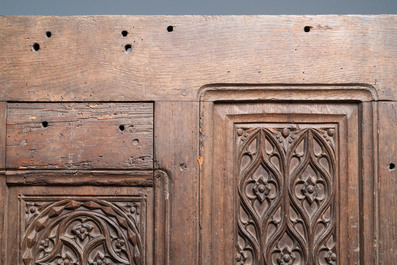 A carved oak front panel of a coffer with tracery panels, 15th C.