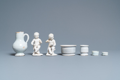 Four white Dutch Delftware ointment jars, a jug and two figures, 17/19th C.