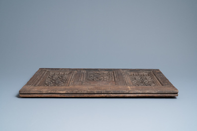 A carved oak front panel of a coffer with tracery panels, 15th C.