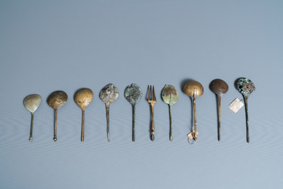 Nine brass spoons and a small fork, 15/16th C.