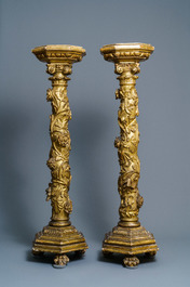 A pair of gilded wooden columns with Ionic capitals, floral swirls and lion paws, Italy, 18th C.