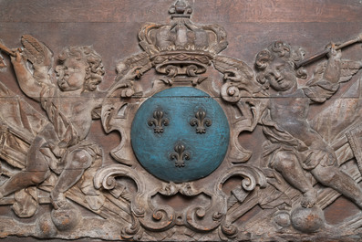 A large polychromed carved oak panel with putti and trophies flanking the royal coat of arms of France, 18th C.