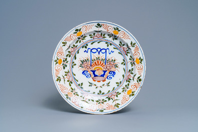 Five polychrome Dutch Delft plates and a dish with flower baskets, 18th C.