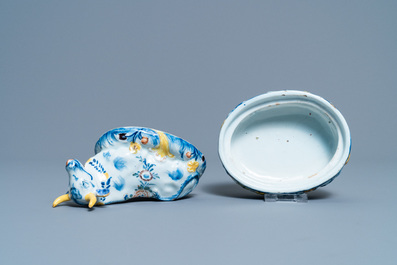 A polychrome Dutch Delft butter tub and cow cover, 18th C.