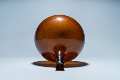 A brown glass bottle, 18th C.