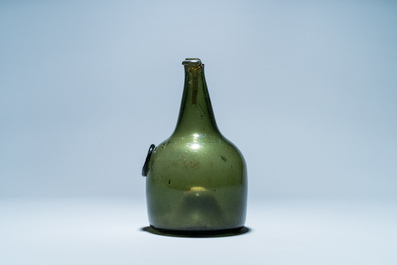 A green glass wine bottle with a crowned alliance seal, 17th C.