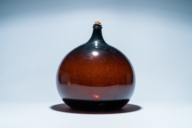 A large brown glass bottle, 18th C.
