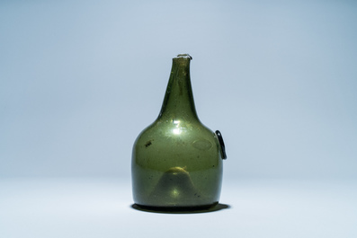 A green glass wine bottle with a crowned alliance seal, 17th C.