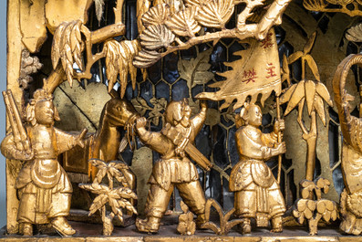 A Chinese gilded wood carving on matching pillars, 19th C.