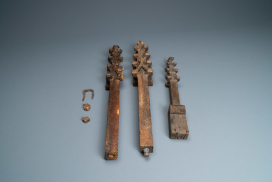 A carved oak shelf with pinnacles and stylised flowers and carved panels, 15th C. and later