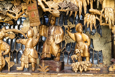 A Chinese gilded wood carving on matching pillars, 19th C.