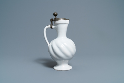A gadrooned white Dutch Delftware jug with pewter cover, 17th C.