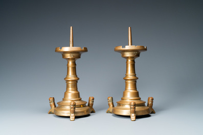 A pair of brass alloy candlesticks on lion feet, The Netherlands, 1st half 15th C.
