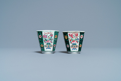 A pair of Chinese octagonal famille rose cups and saucers and a pair of verte biscuit dishes, Kangxi and Qianlong