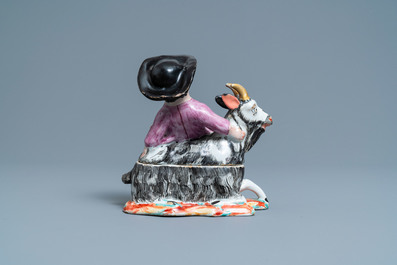 A polychrome Dutch Delft box and cover in the shape of a boy on a goat, 18th C.
