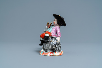 A polychrome Dutch Delft box and cover in the shape of a boy on a goat, 18th C.
