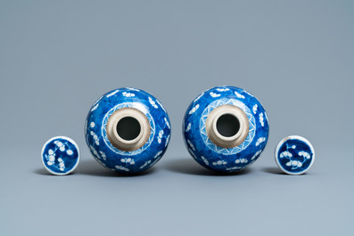 A pair of Chinese blue and white covered bowls on stands and a pair of covered jars, 19th C.