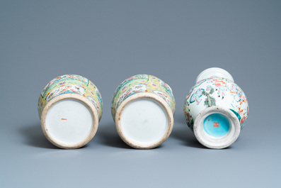 A pair of Chinese Canton famille rose yellow-ground vases and a 'warrior' vase, Qianlong mark, 19th C.