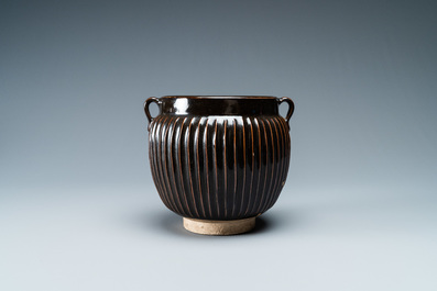 A Chinese black-glazed ribbed two-handled jar, Northern Song or Jin