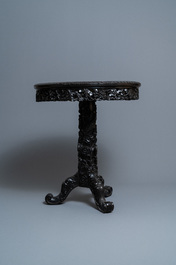A round Chinese carved wooden marble top table, 19th C.
