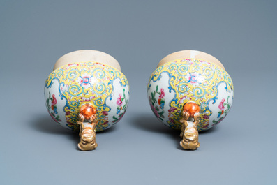 A pair of Chinese Canton famille rose yellow-ground vases and a 'warrior' vase, Qianlong mark, 19th C.