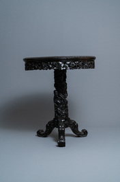 A round Chinese carved wooden marble top table, 19th C.