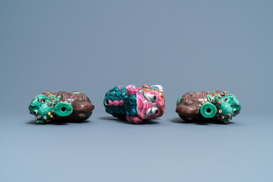 A Chinese famille rose model of a Buddhist lion and a pair of verte biscuit joss stick holders, 19th C.