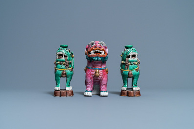 A Chinese famille rose model of a Buddhist lion and a pair of verte biscuit joss stick holders, 19th C.