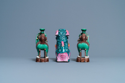 A Chinese famille rose model of a Buddhist lion and a pair of verte biscuit joss stick holders, 19th C.