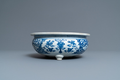 A Chinese blue and white tripod censer with antiquities, Kangxi