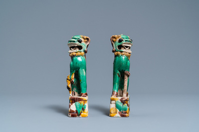 A pair of Chinese sancai models of dogs and a pair of 'Buddhist lions' joss stick holders, Kangxi