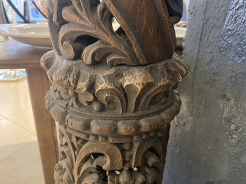 A pair of reticulated carved oak Corinthian columns with cherub heads and vines, 17th C.