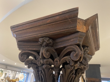 A pair of reticulated carved oak Corinthian columns with cherub heads and vines, 17th C.