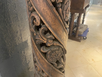 A pair of reticulated carved oak Corinthian columns with cherub heads and vines, 17th C.