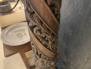 A pair of reticulated carved oak Corinthian columns with cherub heads and vines, 17th C.