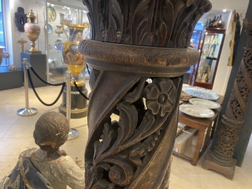 A pair of reticulated carved oak Corinthian columns with cherub heads and vines, 17th C.