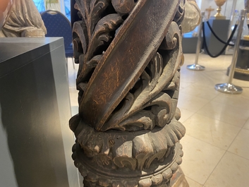 A pair of reticulated carved oak Corinthian columns with cherub heads and vines, 17th C.